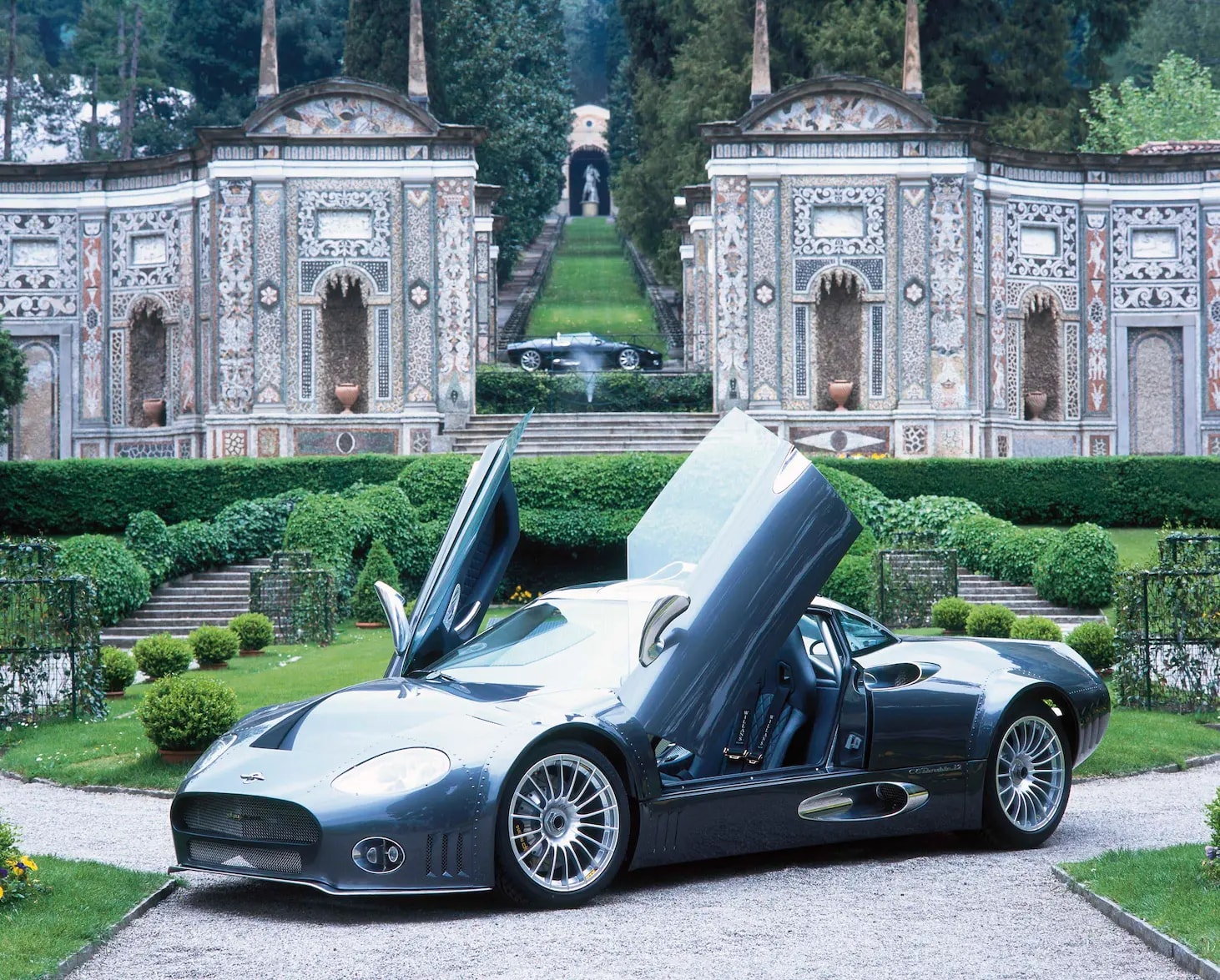 Spyker cars with doors open in a garden